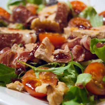 Gourmet summer salad with foie gras and Iberian ham